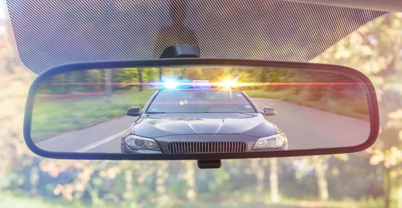 Police car in rearview mirror of a car
