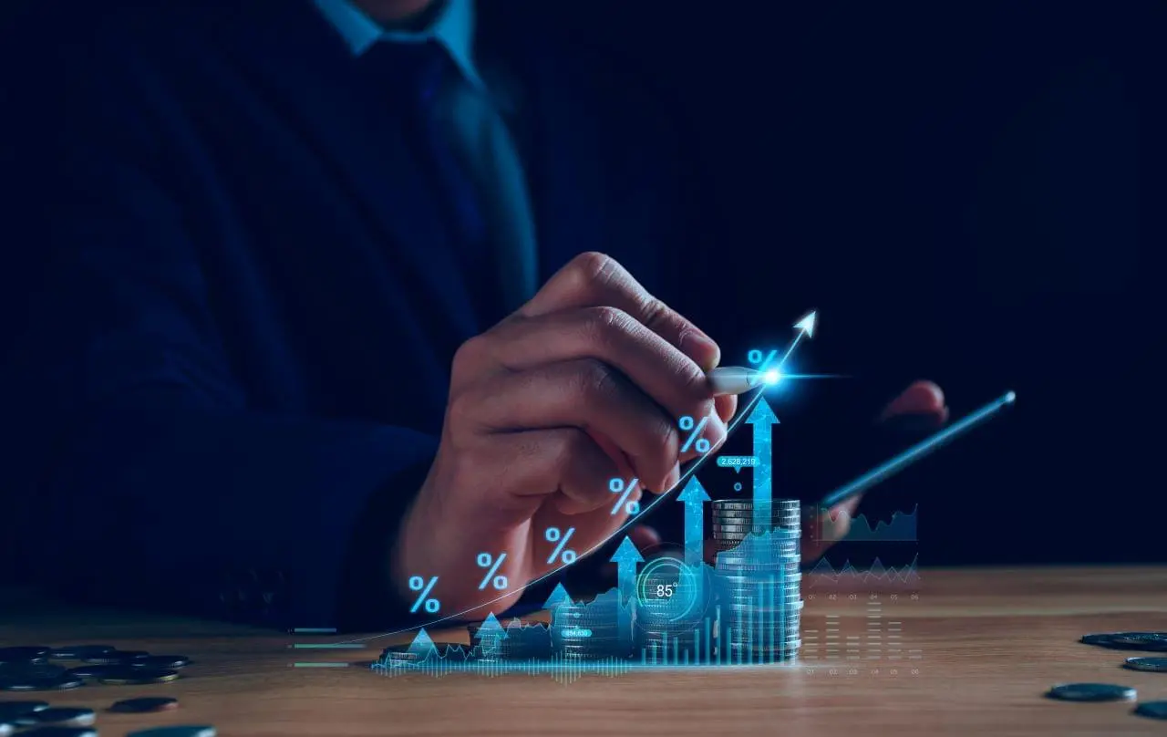 Person pointing at a chart showing reduced costs